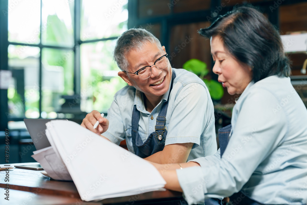 Business owners reviewing documents in their shop